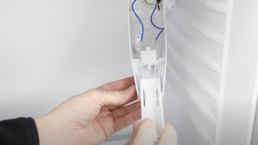 Re-connecting plastic pusher to the fridge freezer